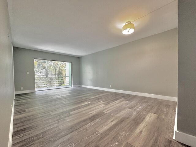 unfurnished room with wood-type flooring