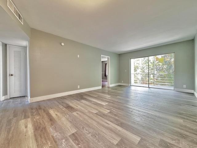 unfurnished living room with wood-type flooring