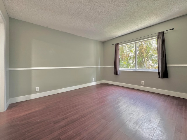 unfurnished room featuring a textured ceiling and hardwood / wood-style flooring