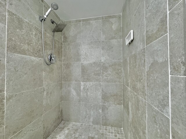 bathroom with tiled shower