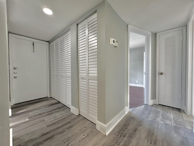 hallway with hardwood / wood-style floors