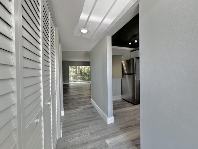 hall featuring ornamental molding and hardwood / wood-style floors