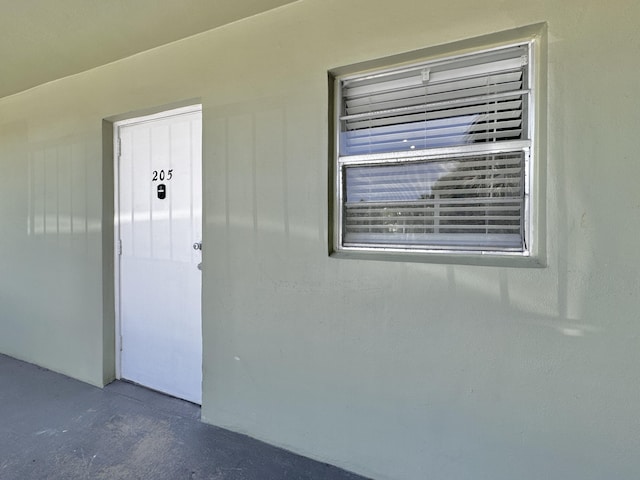 property entrance with stucco siding