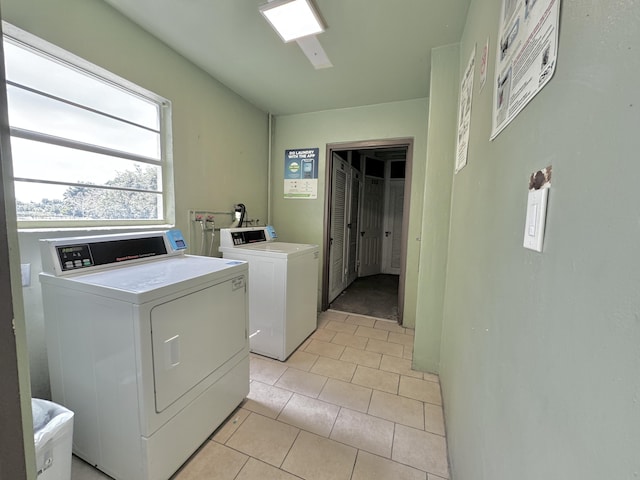 common laundry area featuring light tile patterned floors and separate washer and dryer