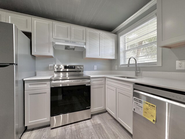 kitchen featuring sink, light wood-type flooring, stainless steel appliances, and white cabinets