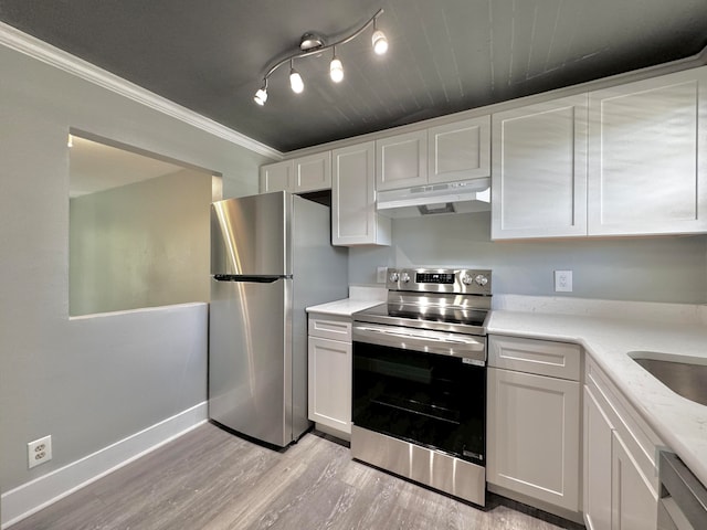 kitchen featuring appliances with stainless steel finishes, light hardwood / wood-style flooring, and white cabinets