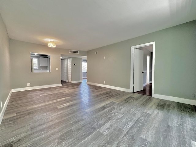 unfurnished living room with wood-type flooring