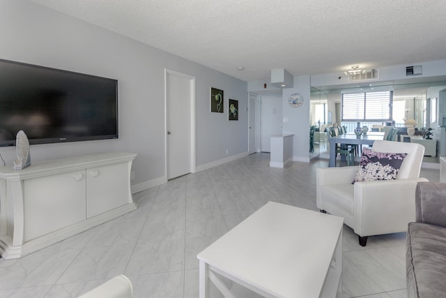 living room with light tile patterned flooring and a textured ceiling