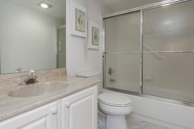 full bathroom with tile patterned flooring, combined bath / shower with glass door, toilet, and vanity