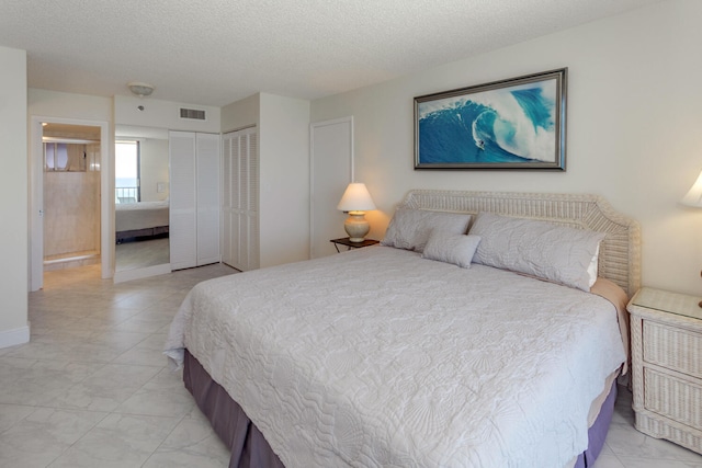 tiled bedroom with a textured ceiling