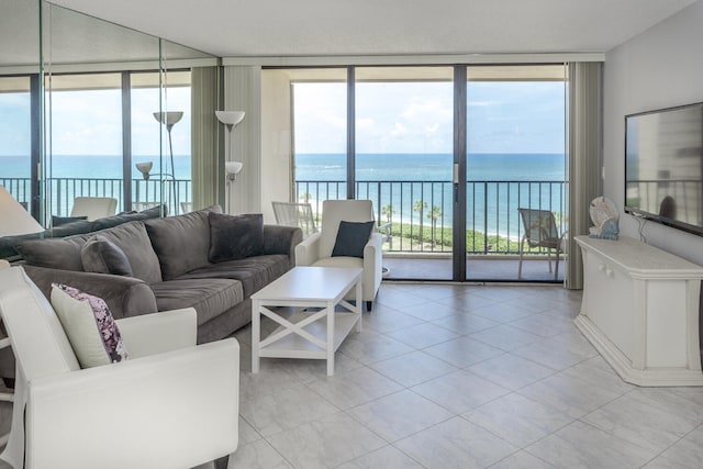 tiled living room with a wall of windows and a water view