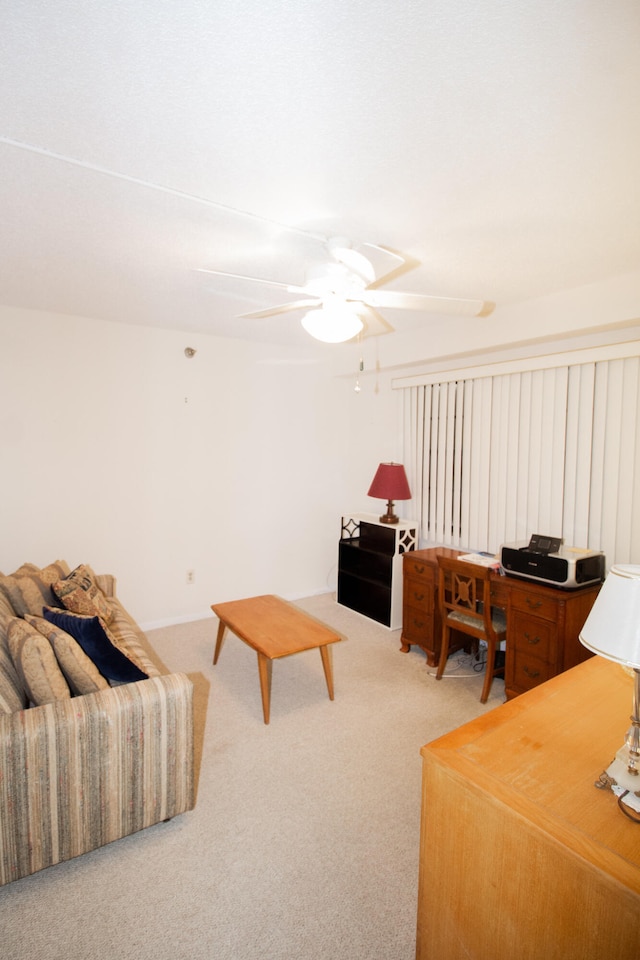 carpeted living room with ceiling fan