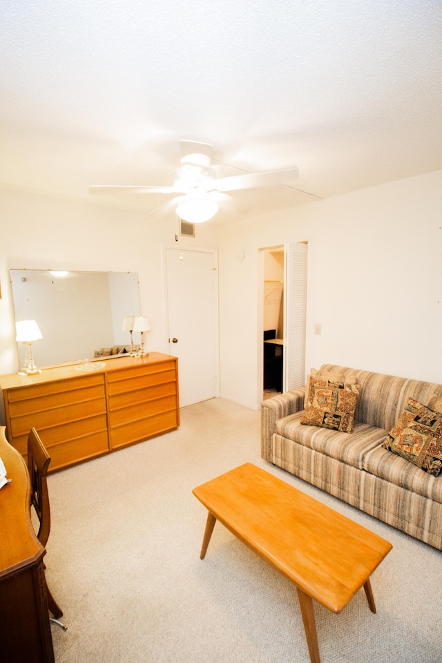 living room with carpet floors and ceiling fan