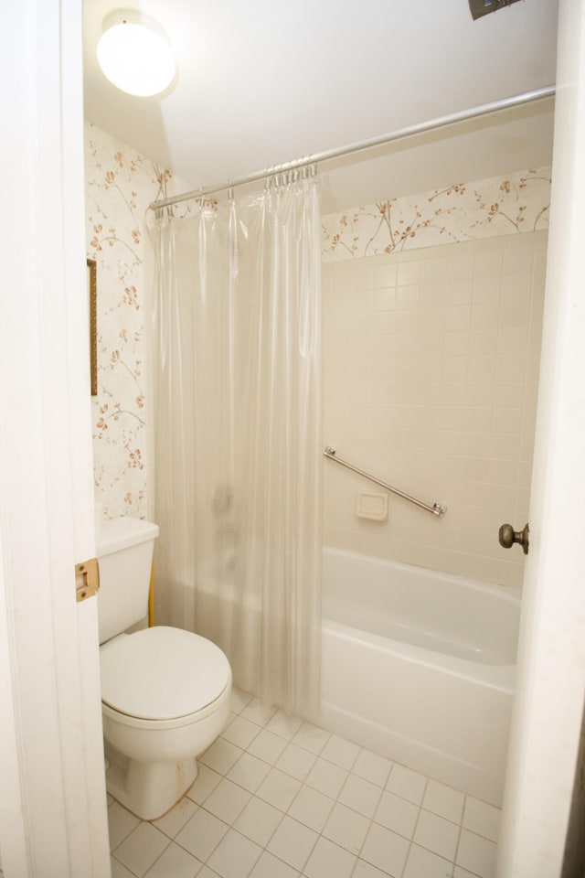 bathroom with tile patterned floors, shower / tub combo with curtain, and toilet