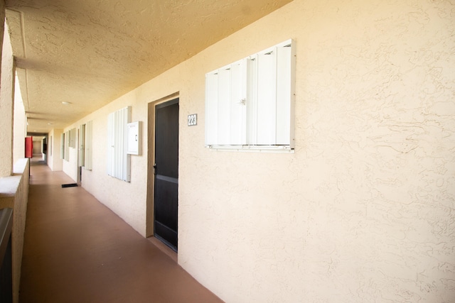 hallway featuring a textured ceiling