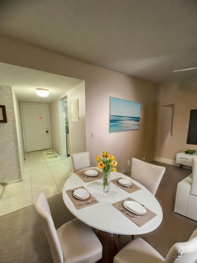 dining space featuring light tile patterned floors