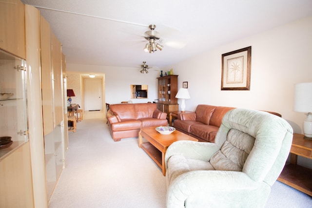 carpeted living room with ceiling fan