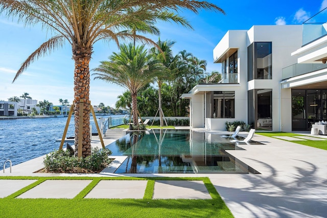 view of swimming pool featuring a water view