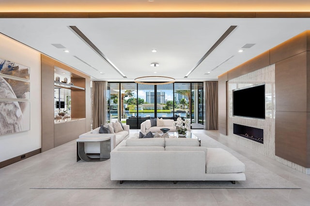 living room with a wall of windows and a fireplace