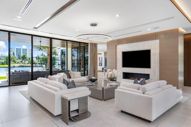 living room with a fireplace and expansive windows