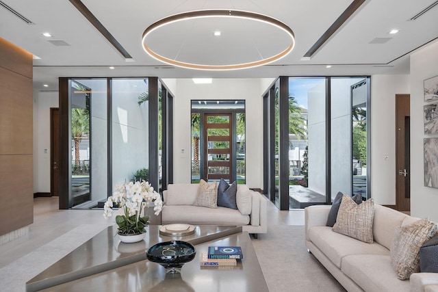 living room featuring expansive windows and a raised ceiling