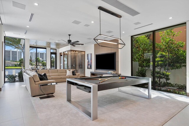 rec room with ceiling fan, light tile patterned flooring, floor to ceiling windows, and billiards