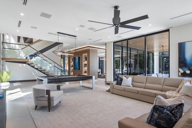 rec room with expansive windows and ceiling fan