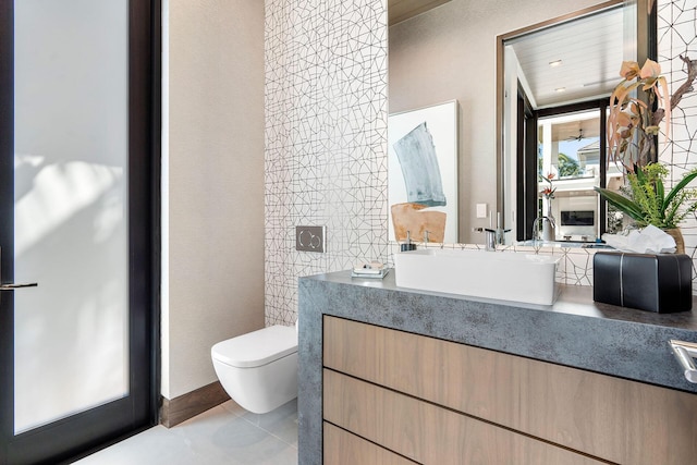 bathroom with vanity, toilet, and tile patterned flooring