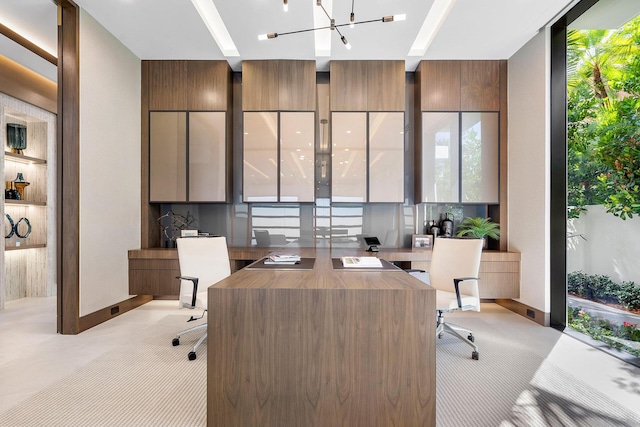 office area with light colored carpet, a notable chandelier, and a wall of windows