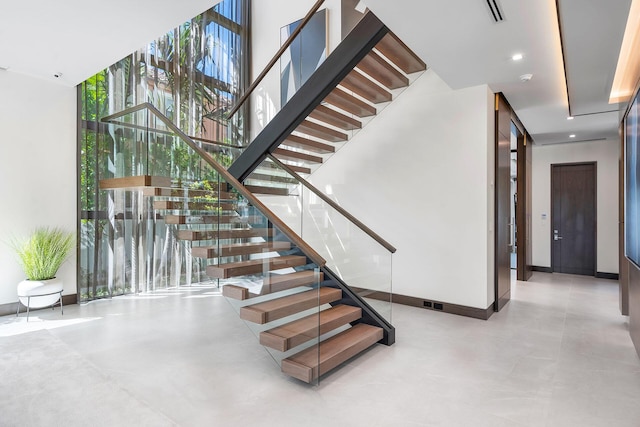 stairs featuring a wall of windows