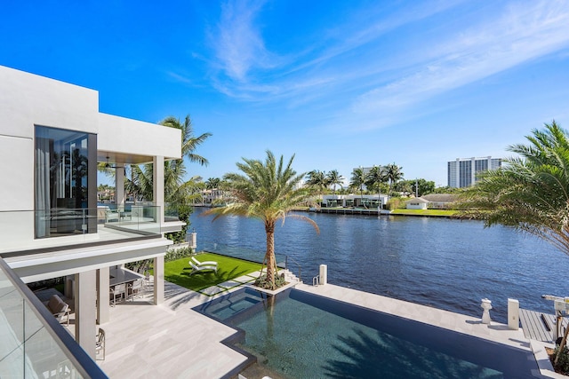 view of dock with a water view, a balcony, and a patio area