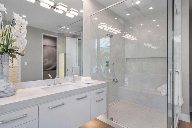 bathroom with vanity and a shower with shower door