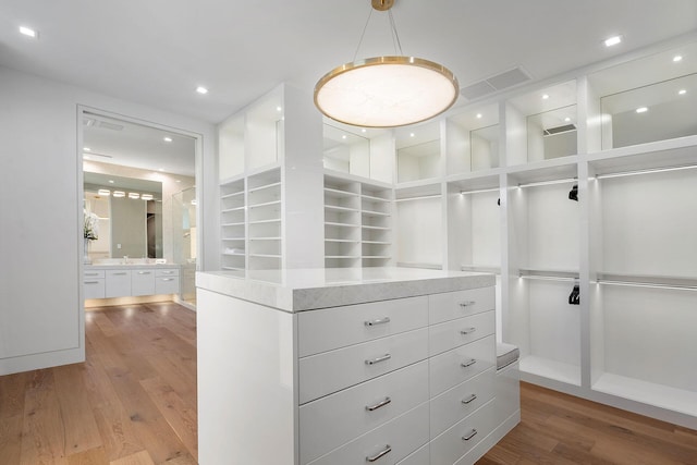 spacious closet featuring hardwood / wood-style floors