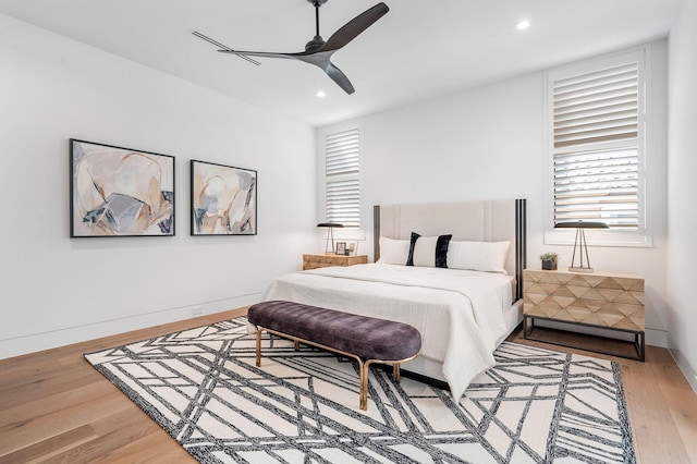 bedroom with hardwood / wood-style floors and ceiling fan