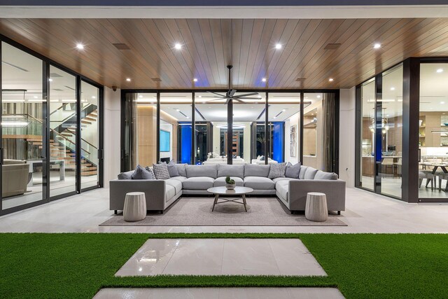 living room with floor to ceiling windows and wooden ceiling