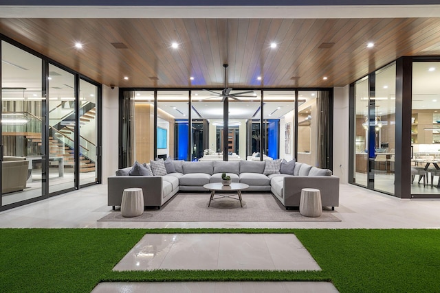 living room with light colored carpet, floor to ceiling windows, and wooden ceiling