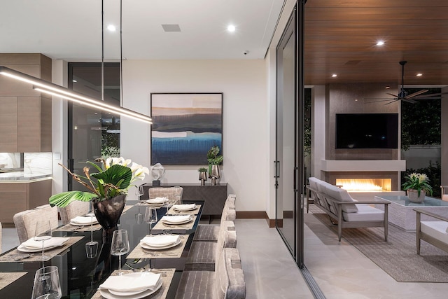 interior space featuring ceiling fan and a fireplace