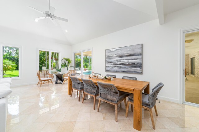 tiled dining area featuring ceiling fan and high vaulted ceiling