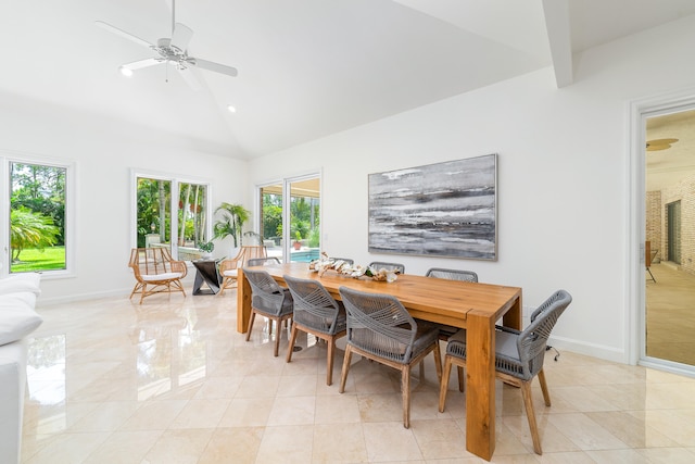 tiled dining space with high vaulted ceiling and ceiling fan