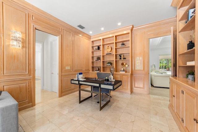 home office featuring built in shelves and ornamental molding