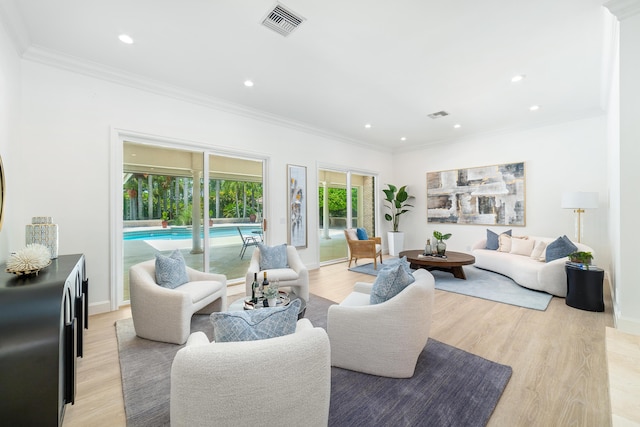 living room with ornamental molding and light wood-type flooring