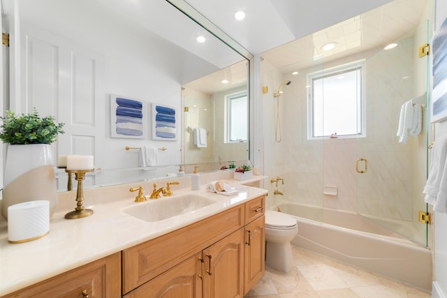 full bathroom with tiled shower / bath combo, vanity, and toilet