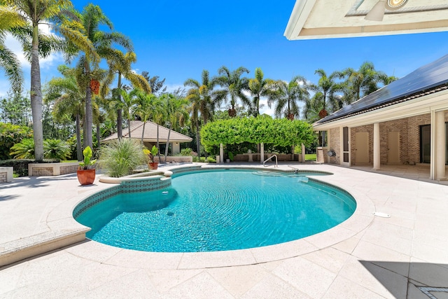 view of pool with an in ground hot tub and a patio