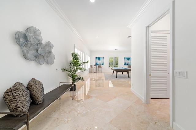 corridor featuring ornamental molding and light tile patterned floors