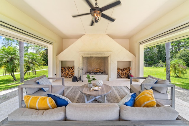 view of patio featuring ceiling fan and a high end fireplace