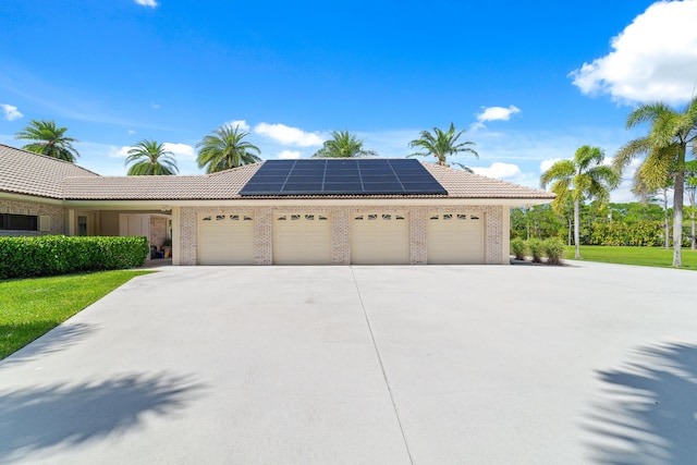 view of front of house with a garage and solar panels