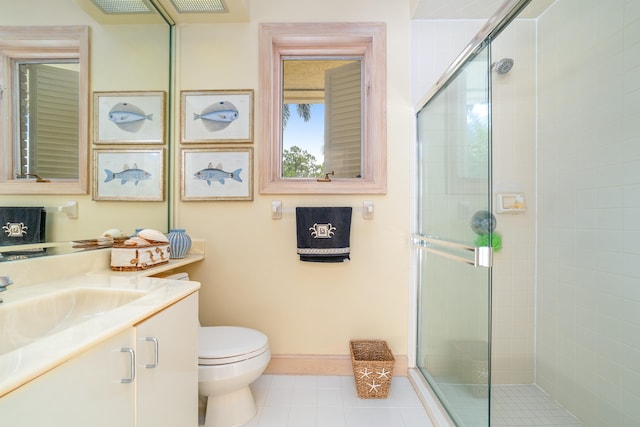 bathroom featuring vanity, toilet, tile patterned floors, and walk in shower