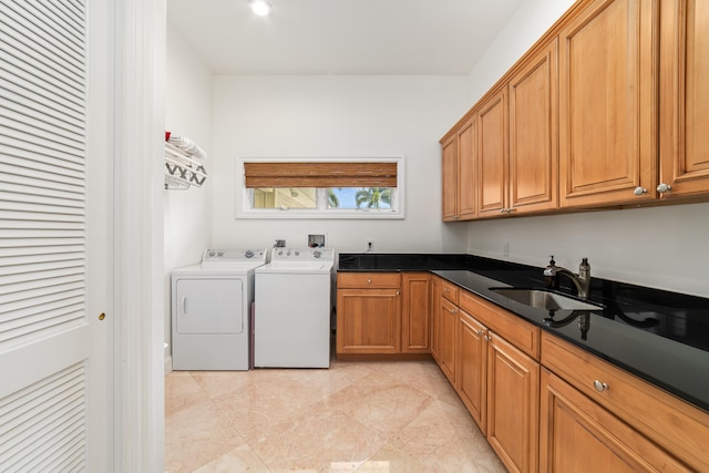 laundry area featuring light tile patterned flooring, washing machine and clothes dryer, cabinets, and sink