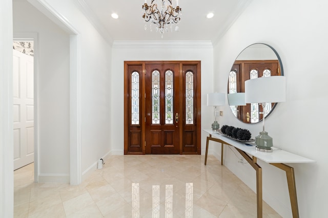 tiled foyer entrance with an inviting chandelier and crown molding