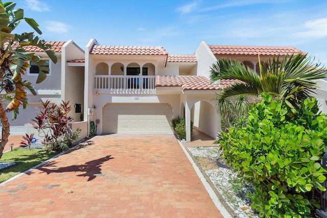 mediterranean / spanish-style house with a balcony and a garage